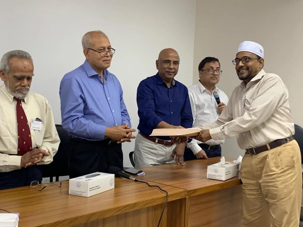 Prof. Ayub Ali receiving a certificate from colleagues