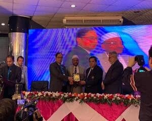 Prof. Ayub Ali receiving an award on stage